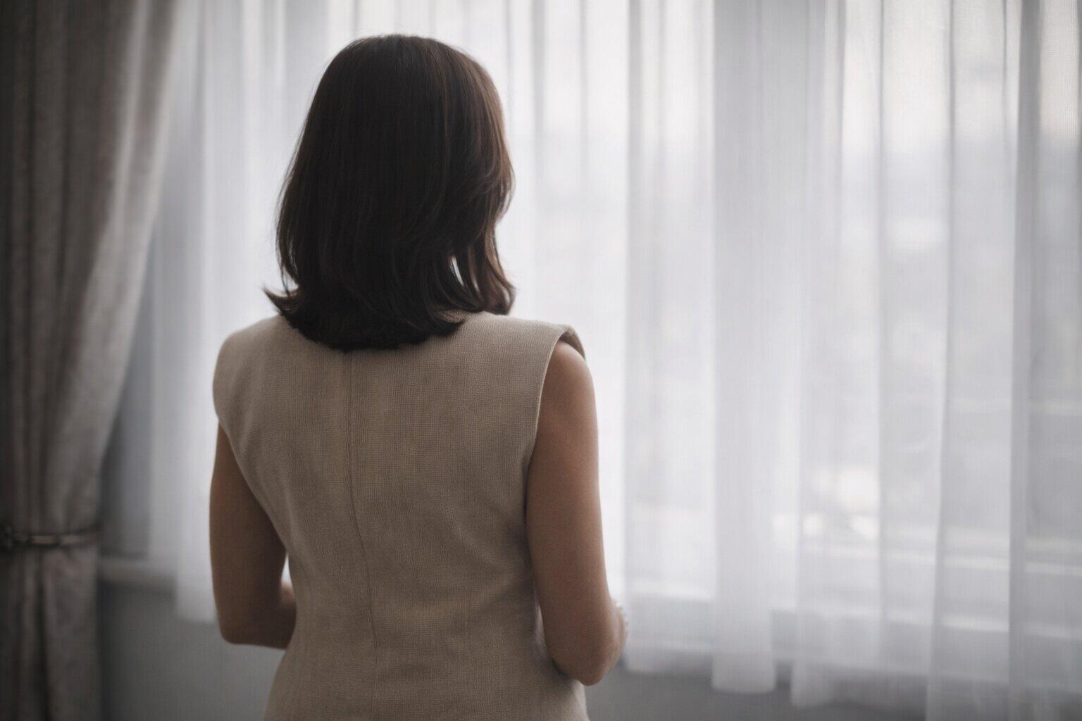 Therapist standing by a window
